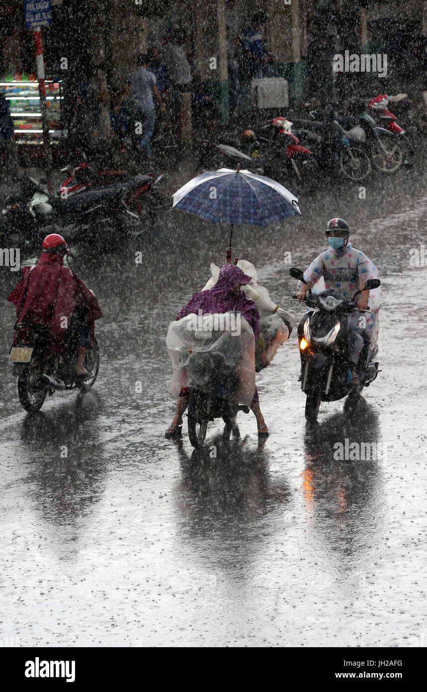 Schweren Monsunregen. Motorroller auf Saigon Street. Vietnam. Stockfoto