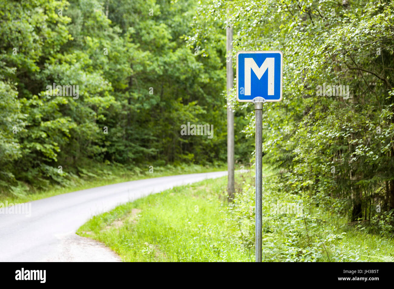 Blaue und weiße Buchstaben M Zeichen Symbole, die auf schwedische Single Track Road in Schweden Model Release: Nein Property Release: Nein. Stockfoto