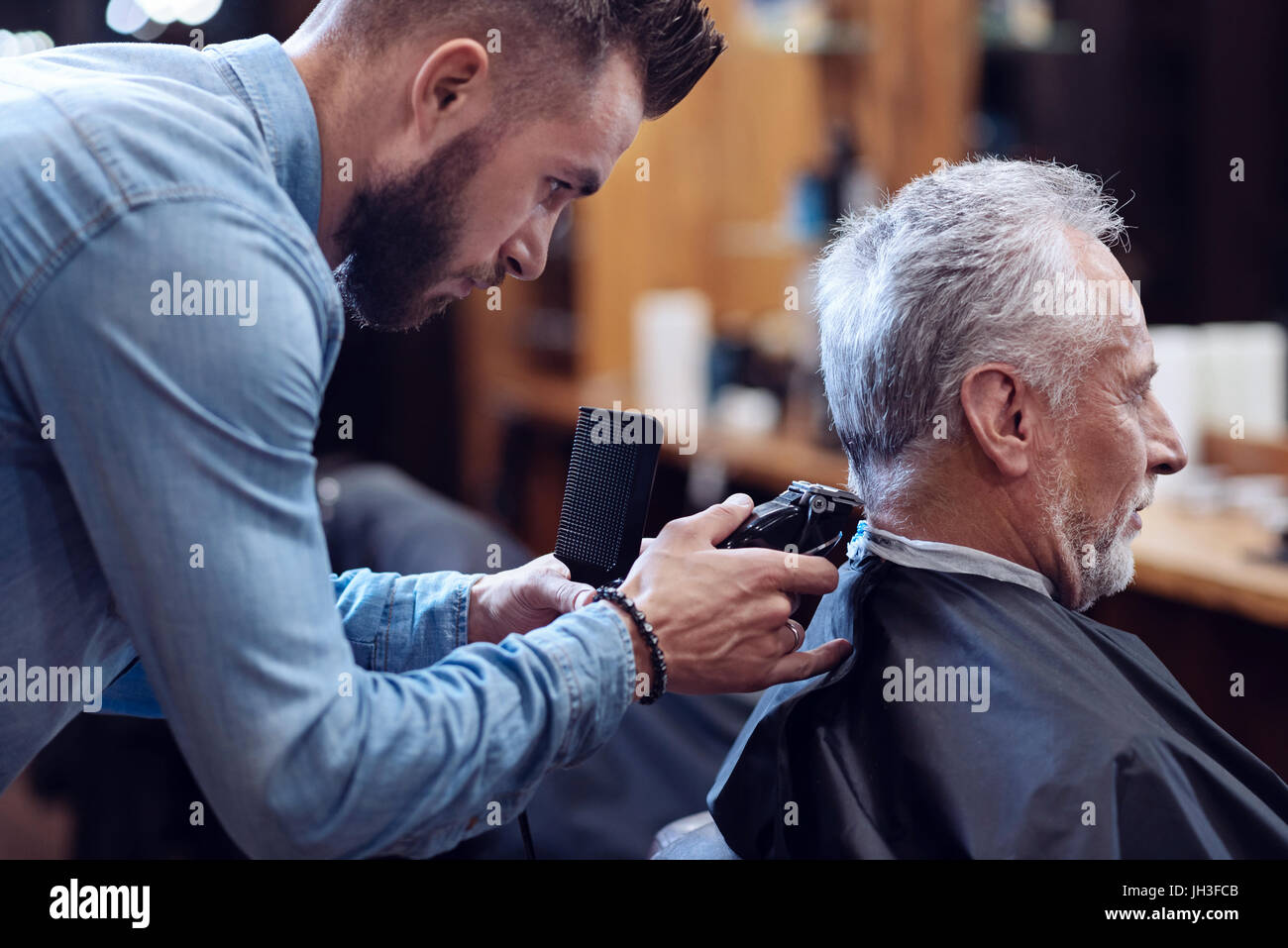 Professionelle erfahrenen Friseur arbeiten mit Haarschneidemaschine Stockfoto