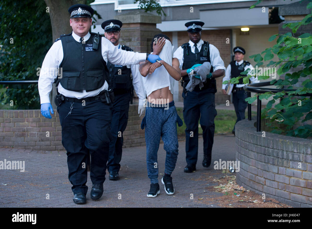 Eine Person ist nach einer Anzahl von Drogen Razzien in einer Wohnsiedlung im Süden von London vor dem Start einer neuen Droge-Strategie von Home Secretary Amber Rudd abgeführt. Stockfoto