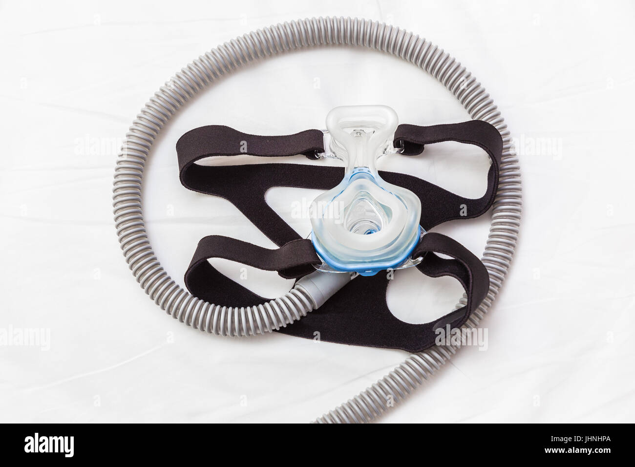 CPAP-Maske, Verbindung mit Gurt und Schlauch auf ein Bett, für Schnarchen Menschen mit Atemwegserkrankungen Problem helfen Stockfoto