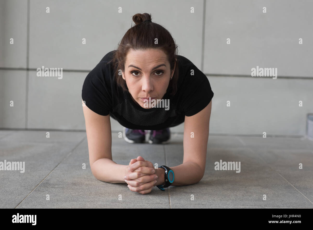 Porträt von Fit Frau tun Liegestütze vor Gebäude Stockfoto