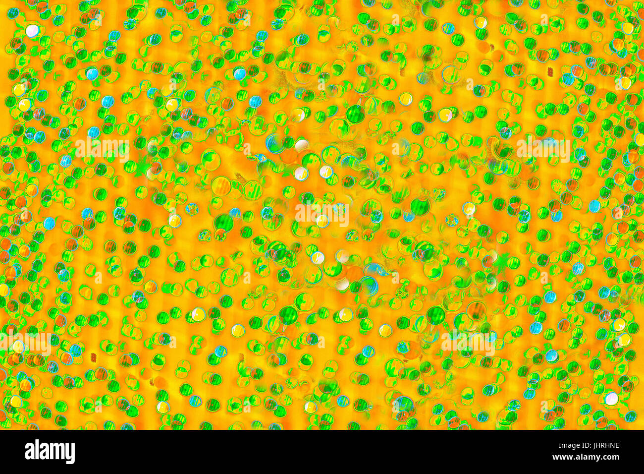 Bokeh-Abstraktion: Gelb-Orange Pop-Art Hintergrund übersät mit Grün Stockfoto
