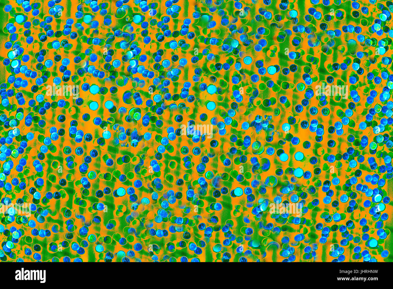 Bokeh-Abstraktion: Orange-grünen Hintergrund gestreut mit blaue Kreise Stockfoto