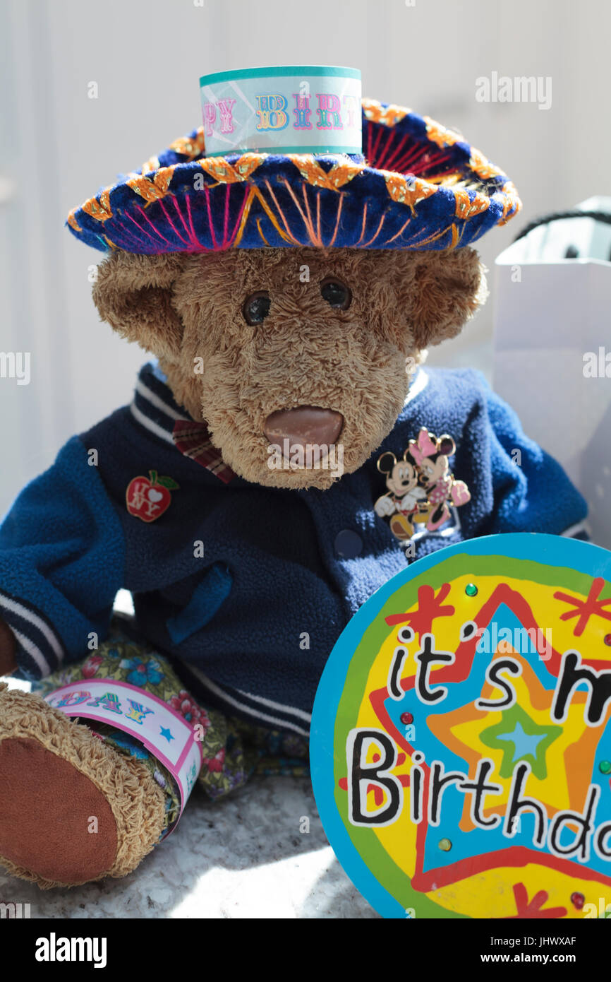 Teddybär in Tracht mit Happy Birthday-Abzeichen Stockfoto