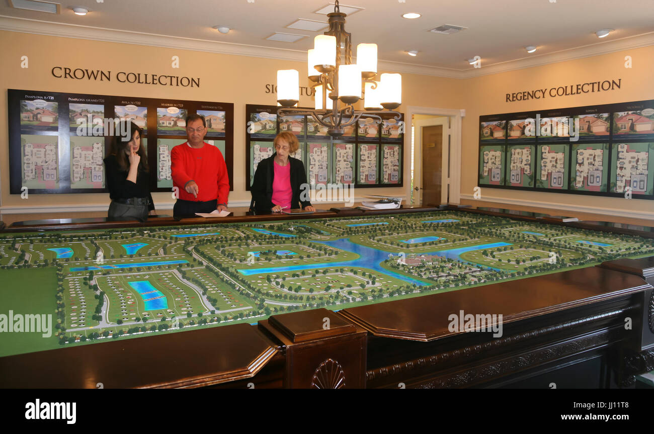 Immobilien Vertriebsbüro für eine neue Wohnanlage in Florida. Verkäufer zeigt ein Mann & Frau, Interessenten, neue Musterhäuser & Layout. Stockfoto