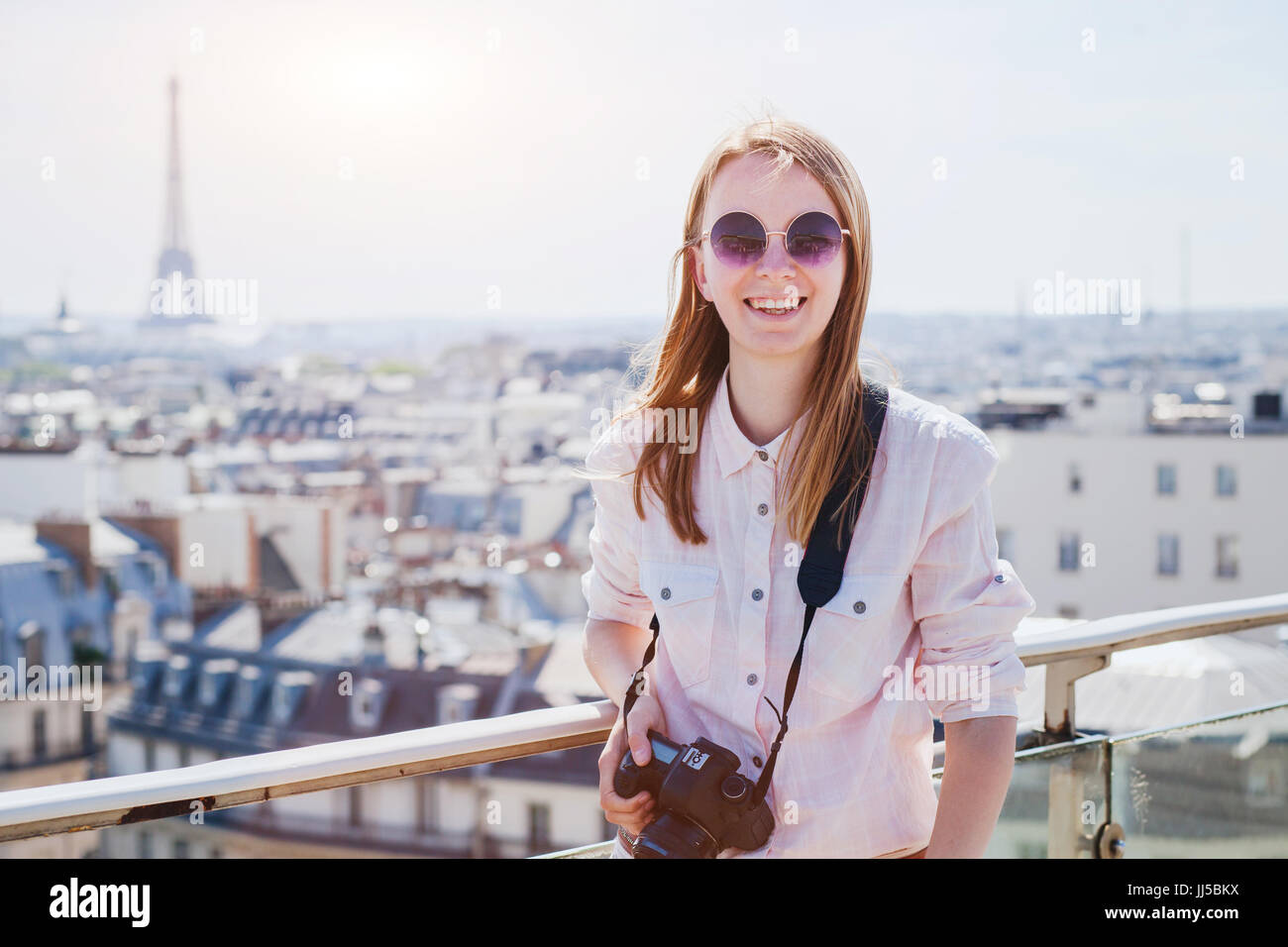 Portrait von Glücklich lächelnde Frau Touristen mit Kamera in Paris, Sightseeing oder Reisen Hintergrund Stockfoto