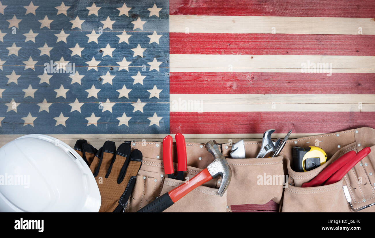 Tag der Arbeit-Hintergrund mit rustikalen hölzernen Flagge USA und Dienstprogramm Gürtel plus Schutzhelm Stockfoto
