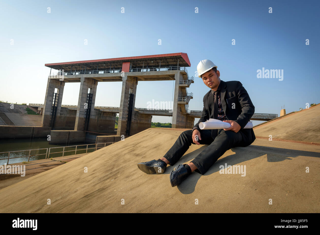 Mit einen jungen Ingenieur sitzt traurig und verärgert am Arbeitsplatz nicht erfolgreich. Stockfoto