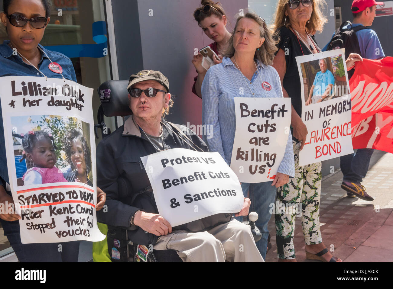 London, UK. 18. Juli 2017. Menschen halten Plakate, darunter zwei Menschen ums Leben nutzen Kürzungen bei den Protest außerhalb Kentish Town Jobcentre durch WinVisible, vereinen, Camden, Kilburn arbeitslose Arbeitnehmer Gemeinschaftsgruppe, alleinerziehende Mütter Selbstverteidigung, Camden Impuls, englische kollektive von Prostituierten, alle afrikanischen Frauengruppe und andere behinderte Menschen gegen Kürzungen Tag des lokalen Aktionen über das Land gegen die Wirkung von profitieren, Schnitten und Sozialreformen auf die Armen und insbesondere auf Menschen mit Behinderungen. Bildnachweis: Peter Marshall/Alamy Live-Nachrichten Stockfoto