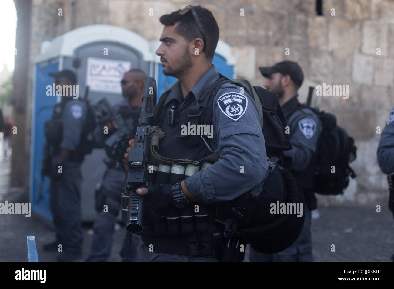 Jerusalem, Israel. 19. Juli 2017. Muslime halten Nachmittagsgebet außerhalb Löwentor, wie israelische Polizei aussehen auf. Auseinandersetzungen zwischen muslimischen Demonstranten und Polizei außerhalb Löwentor in die Altstadt von Jerusalem. Bildnachweis: Louise Wateridge/Pacific Press/Alamy Live-Nachrichten Stockfoto