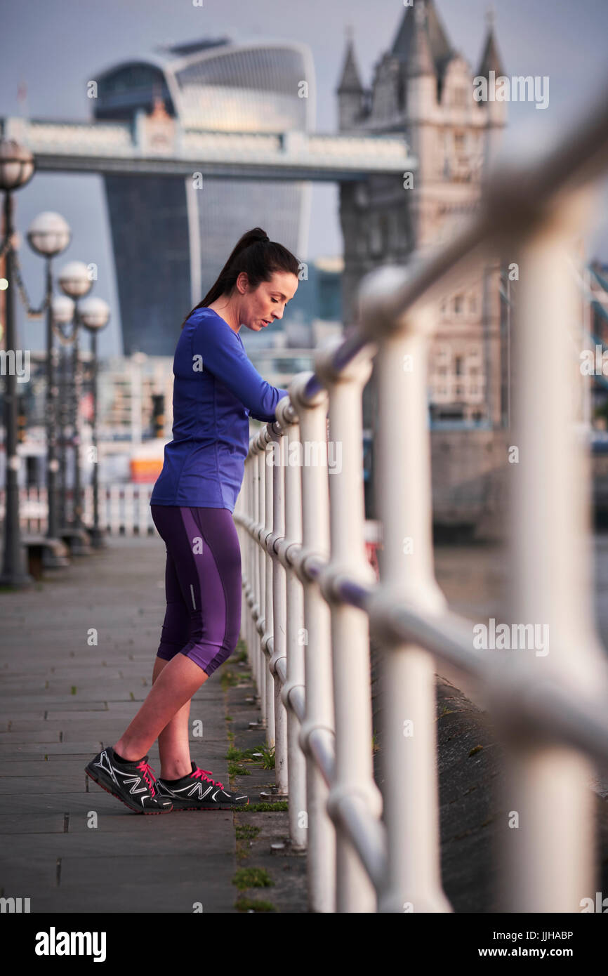 Eine Frau, ruhen Sie sich nach einem Lauf der Themse in London. Stockfoto