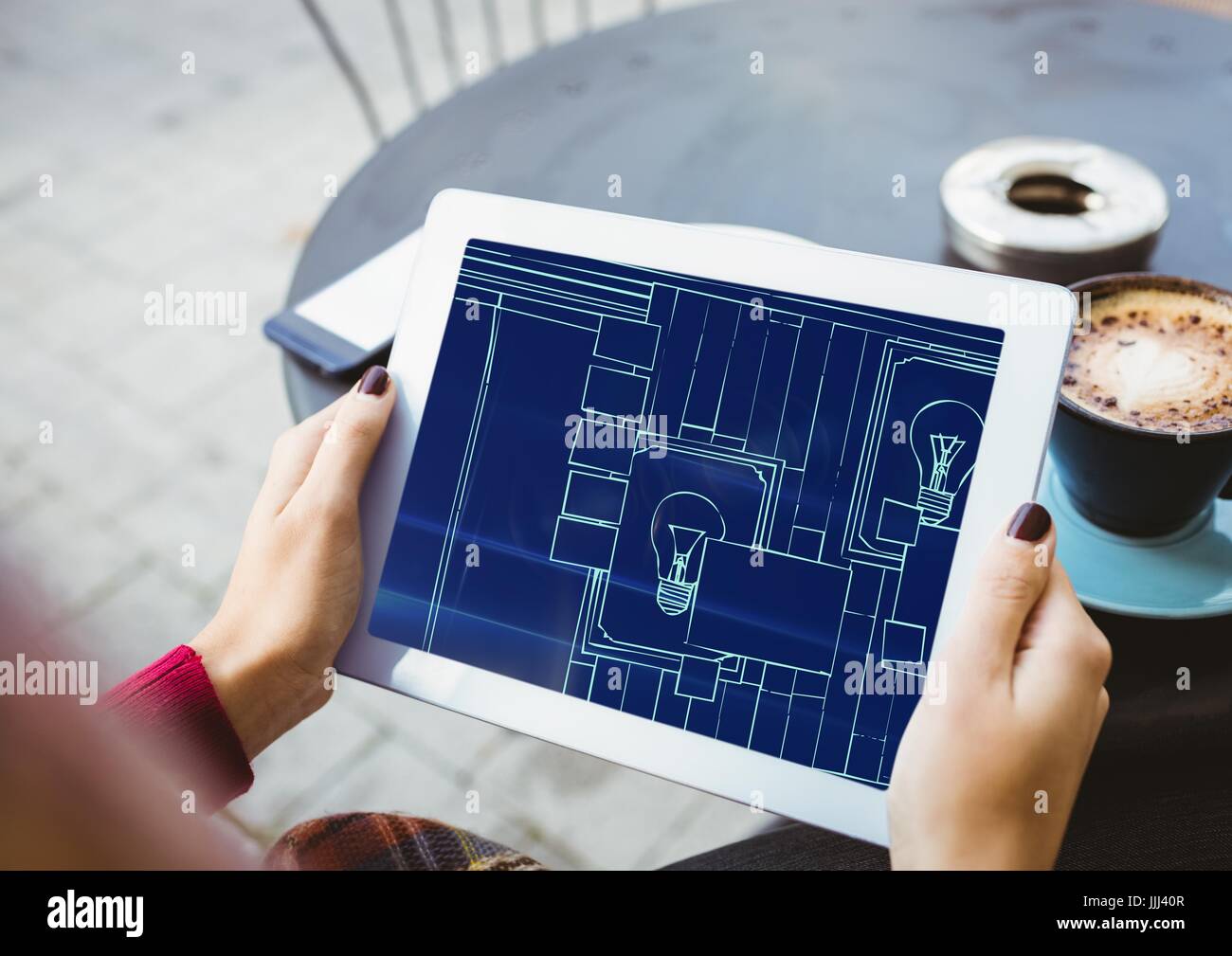 Hände mit Tablet mit Blaupause drauf (zweifarbig: dunkelblau und hellblau) Stockfoto
