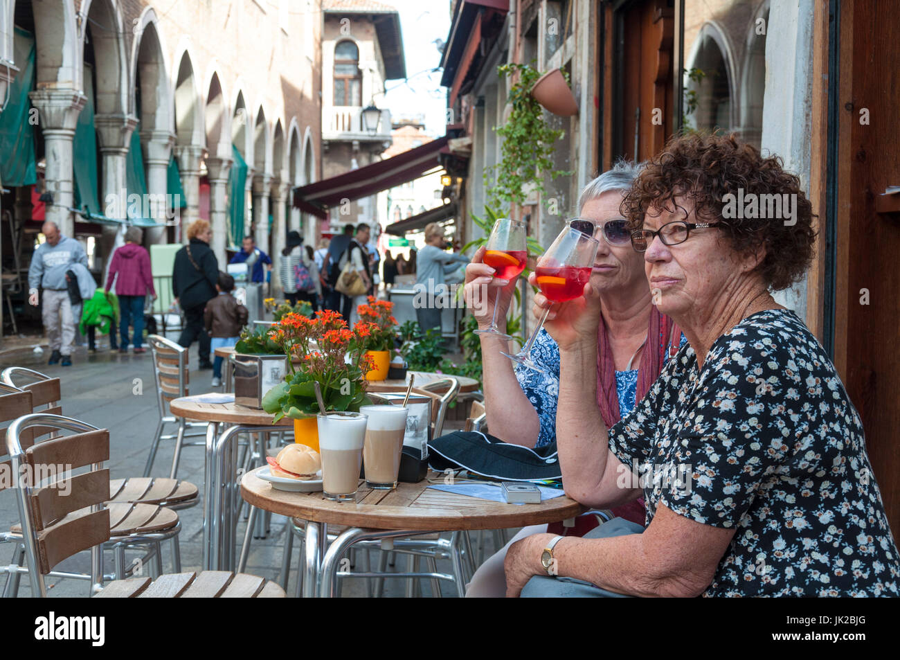 Zwei Frauen trinken einen Spritz, ein traditionelles alkoholisches Getränk in Venedig, Italien Stockfoto