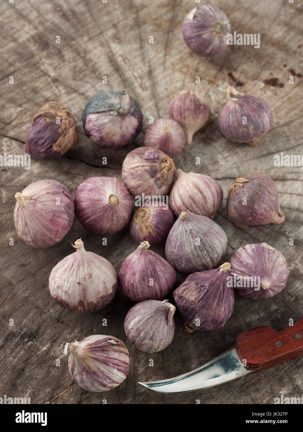 Stillleben-Kunst der einzelnen Lampe Form von Elefanten Knoblauch auf hölzernen Hintergrund mit Messer Stockfoto