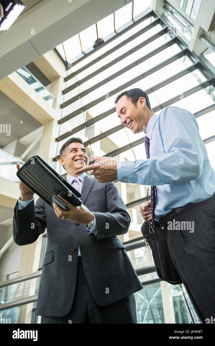 Lächelnde Geschäftsleute mit digital-Tablette in lobby Stockfoto