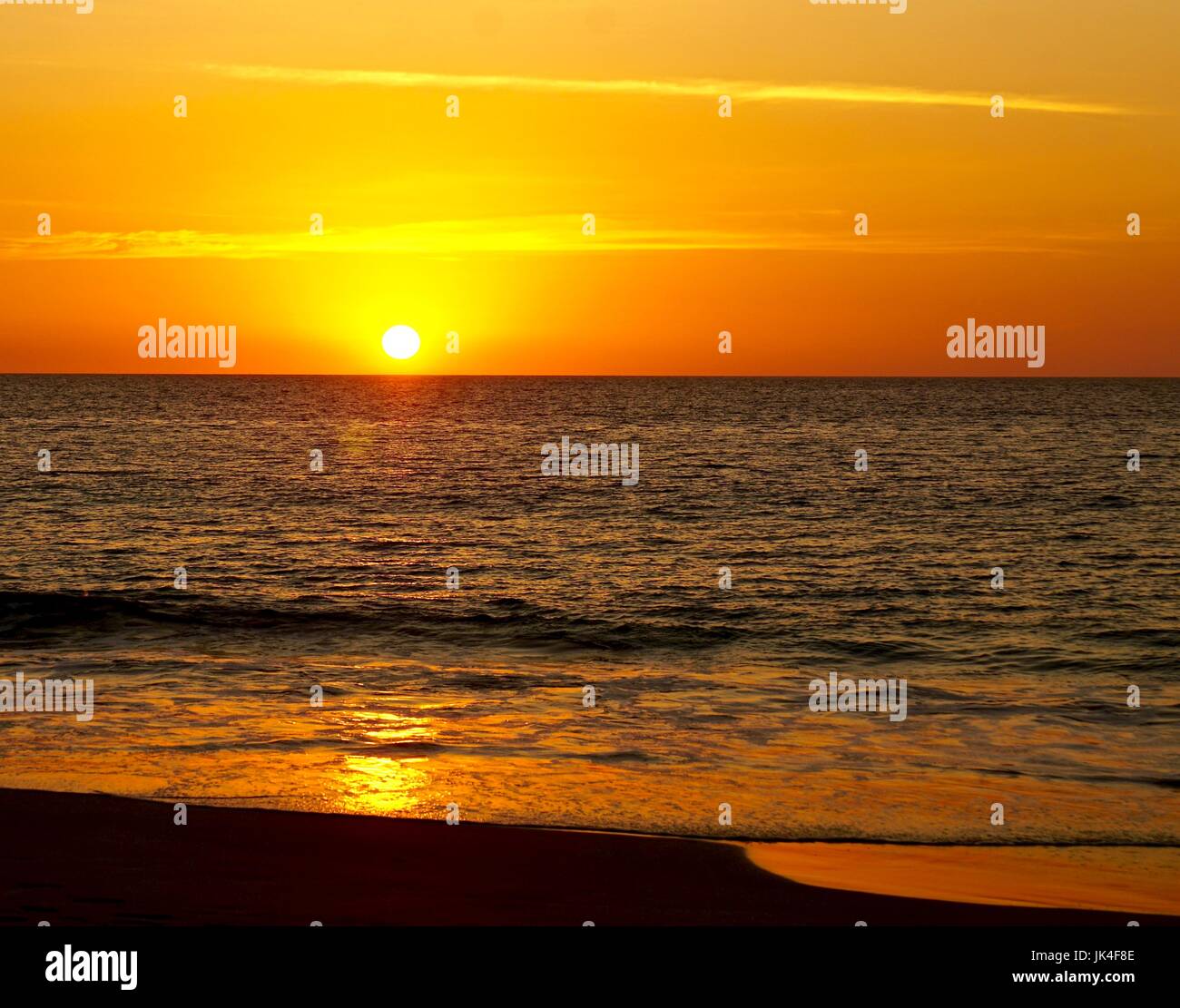 Sonnenuntergang am Sandstrand Stockfoto