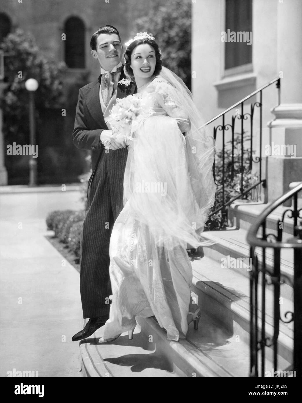 GAIL PATRICK (1911-1980) US film Schauspielerin und späteren TV-Produzent von "Perry Mason" in einem Mode-Shooting im Juli 1936 für eine Hochzeit Gowen von Travis Banton entworfen. Mit ihr ist größter Vertrag Schauspieler Wolfe Hopper Stockfoto