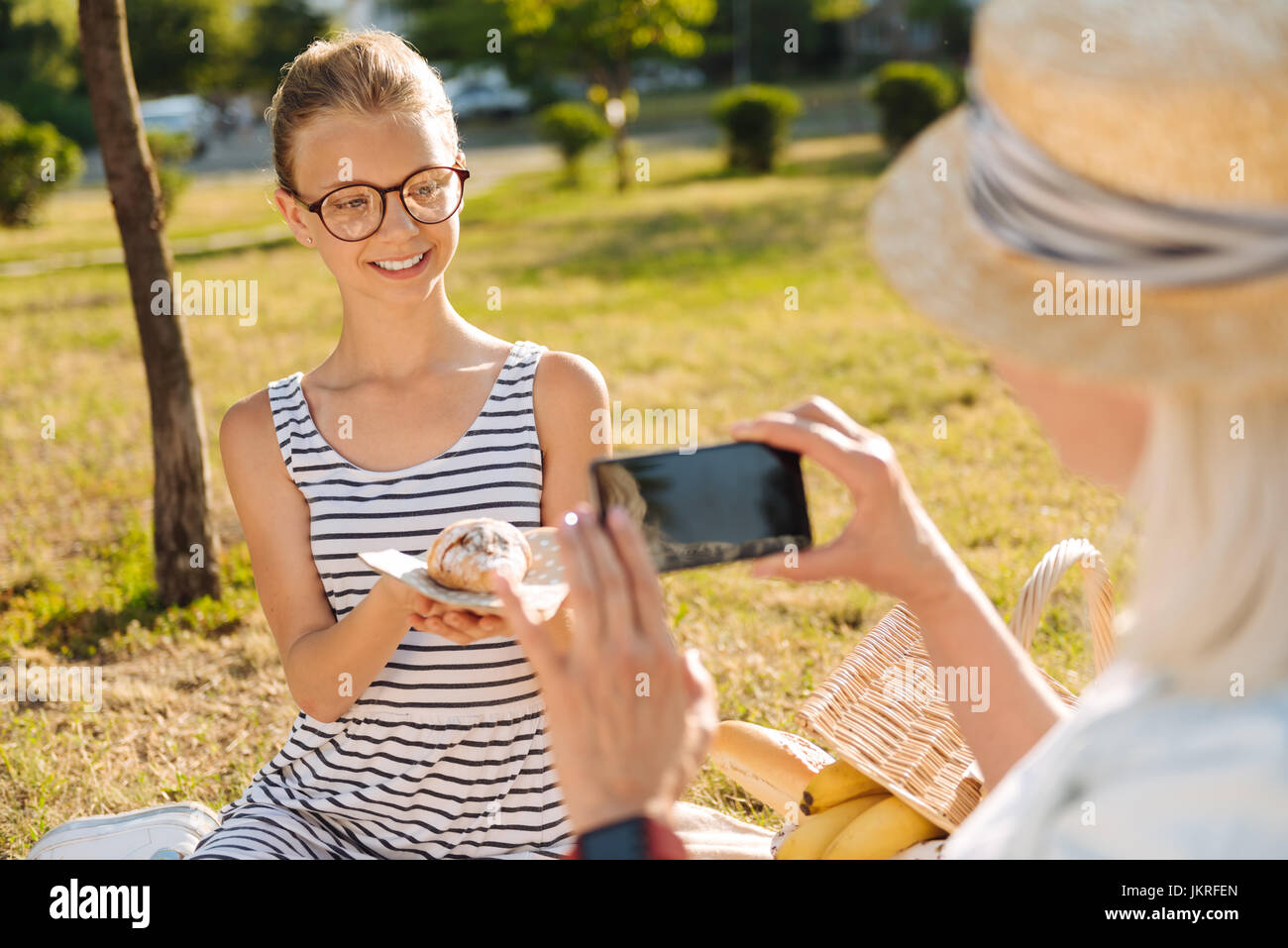 Fröhliche Teenager Mädchen posiert auf einem Picknick mit croissants Stockfoto