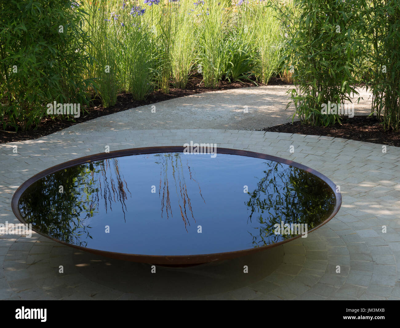 Hampton Court Schaugarten - Heiligtum Staudengarten von Tom Massey entworfen.  Vergoldete Silbermedaille.  Kreisförmige Wasserbecken / feature in der zentralen gepflastert Stockfoto