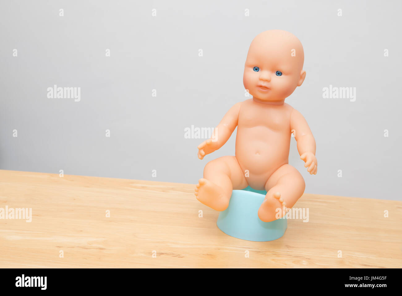 Puppe sitzt auf Töpfchen, Illistrate Töpfchen-training Stockfoto