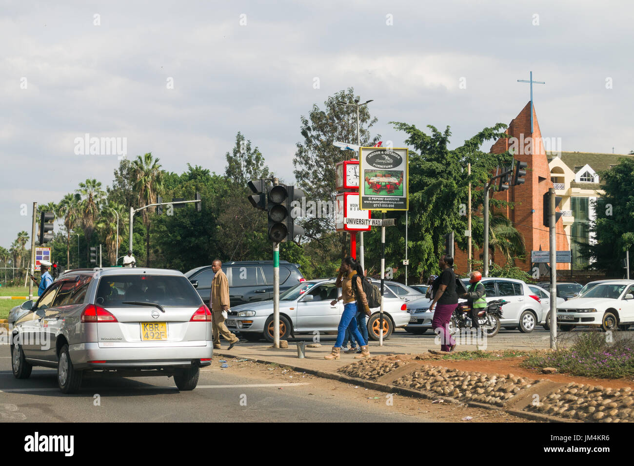Fußgänger überqueren University Way Uhuru Highway Kreisverkehr mit Verkehr warten, Nairobi, Kenia Stockfoto