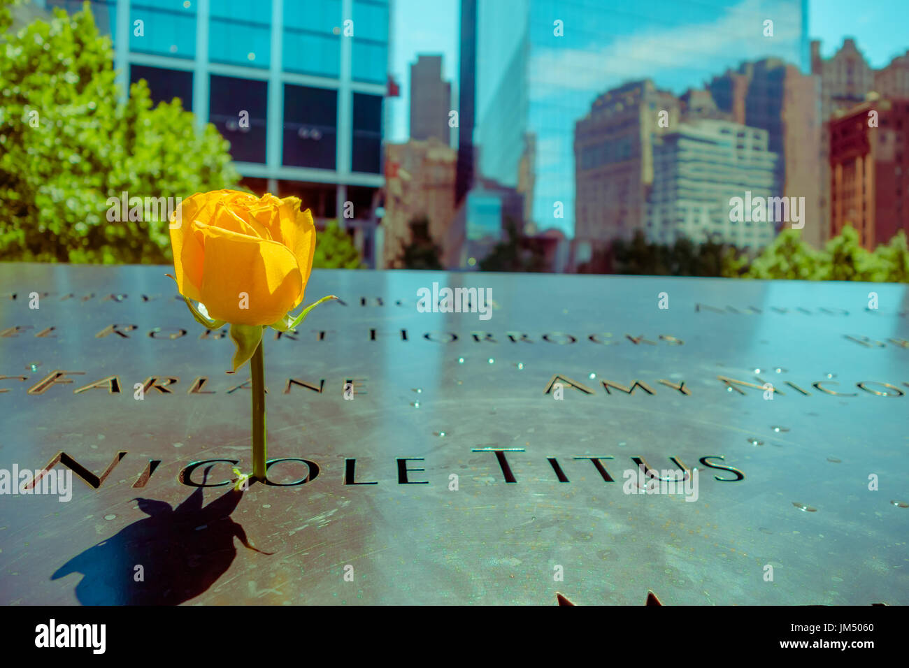NEW YORK, USA – 5. Mai 2017: Gelbe Blüte im Inneren einen Fußabdruck Namen auf 911 Memorial World Trade Center in New York Usa Stockfoto