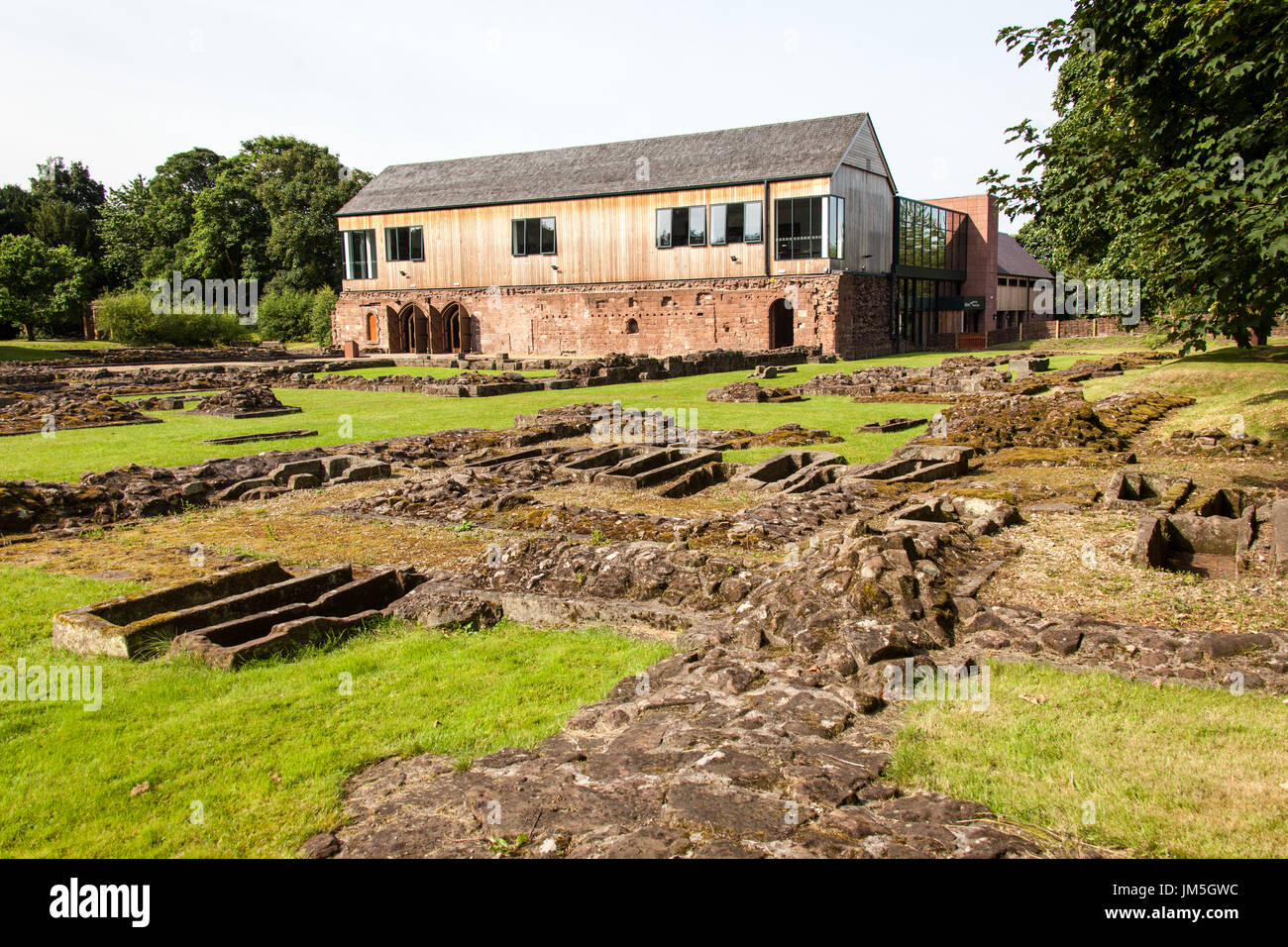 Norton Priory Museum & Gärten. Norton Priory Ruinen und Grabstätten mit der Unterkirche im Hintergrund. Stockfoto