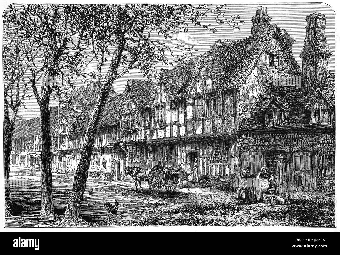 1870: mittelalterlichen Fachwerkhäusern unter Warwick Castle, Warwickshire, England. Stockfoto