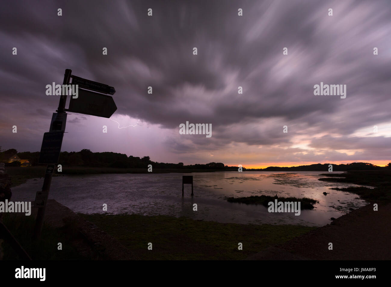 Die Causway, Wanderweg, Nacht, Cark, Blitzschlag, Sturm, Fluss, Yar, Sonnenaufgang, Wolken, Umzug, verschwommen, alt, Bahn, Linie, Zeichen, Road, frühmorgens, gegabelt, Wasser, Bäume, Unkraut, Yarmouth, Freshwater, Silhouette, Isle Of Wight, Blitzschlag, Sturm Stockfoto
