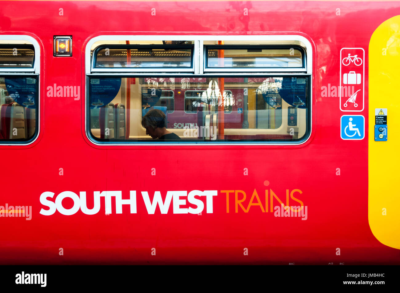 Ein Zug in der South West Trains Lackierung mit dem Firmenlogo auf der Seite der Fahrgastraum. Stockfoto