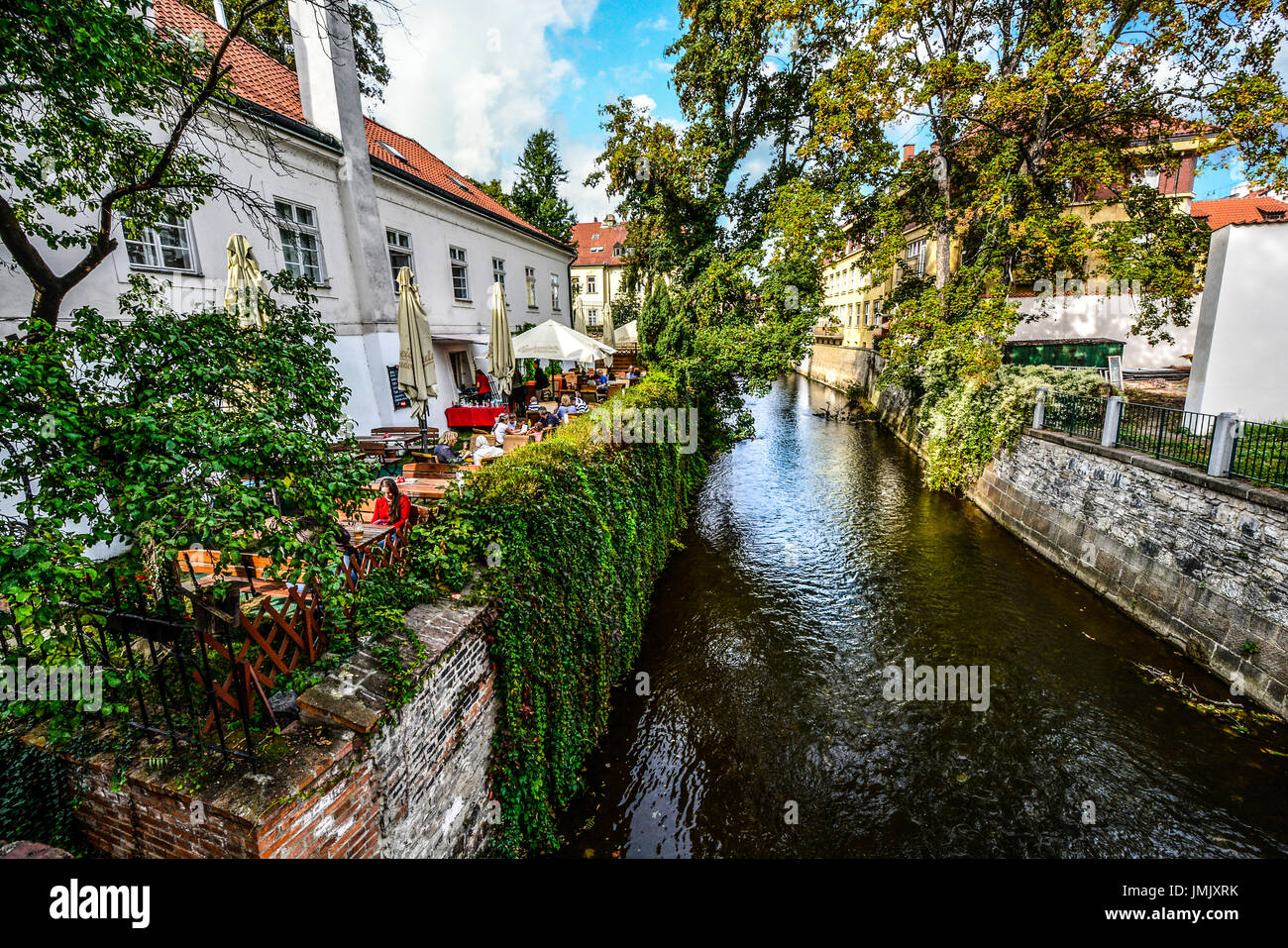 Café bar Nad Čertovkou auf Insel Kampa in Prag. Gäste beim Mittagessen in einer ruhigen Umgebung außerhalb entlang eines Kanals Stockfoto