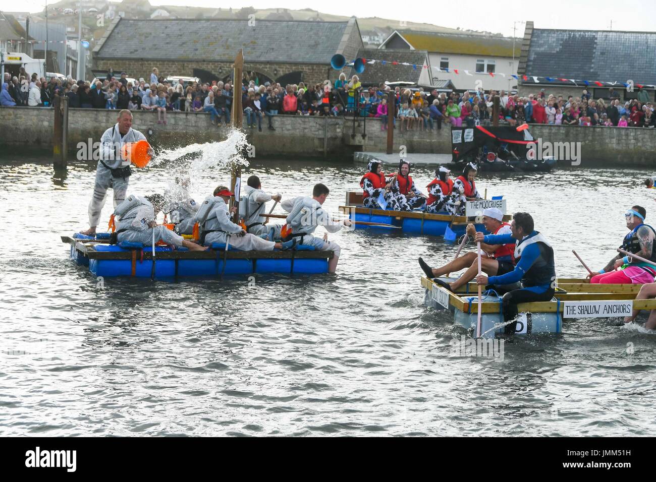 West Bay, Dorset, UK.  27. Juli 2017.  Jährliche RNLI Floß Rennen auf dem Fluss Brit im Badeort von West Bay in Dorset.  Teilnehmer unter dem Motto Kostüm tragen und gründlich nass, als sie Wasserschlachten auf der Startlinie.  Bildnachweis: Graham Hunt/Alamy Live-Nachrichten Stockfoto