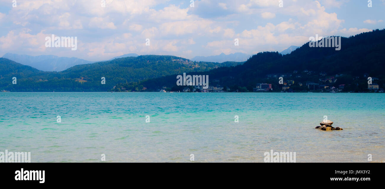 Eine markante Landschaft am Wörthersee, Österreich - bläuliche Bergen in Türkis blaues Wasser sinken Stockfoto