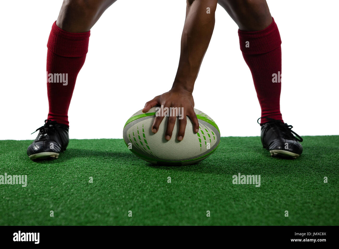 Geringer Teil der Sportler mit Rugby-Ball auf Feld vor weißem Hintergrund Stockfoto