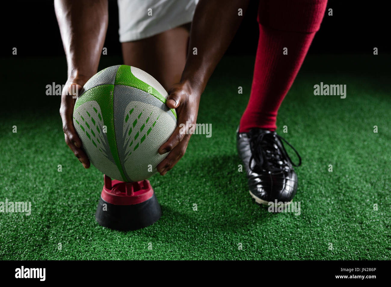 Nahaufnahme von Sportler halten Rugby-Ball am Abschlag am Feld Stockfoto