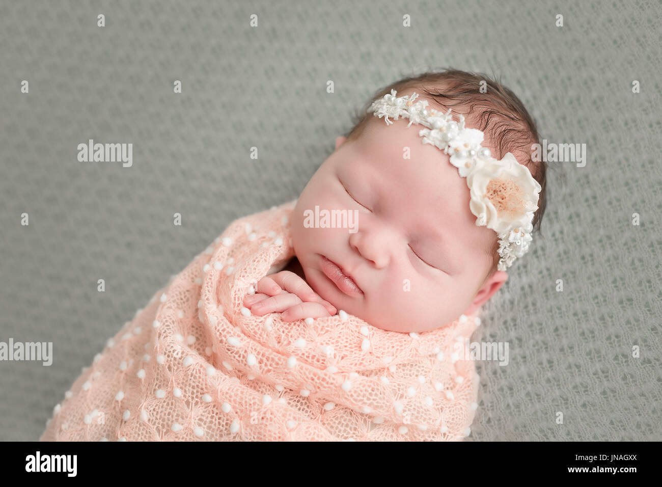 Schlafendes neugeborenes Mädchen in eine Decke gewickelt Stockfoto