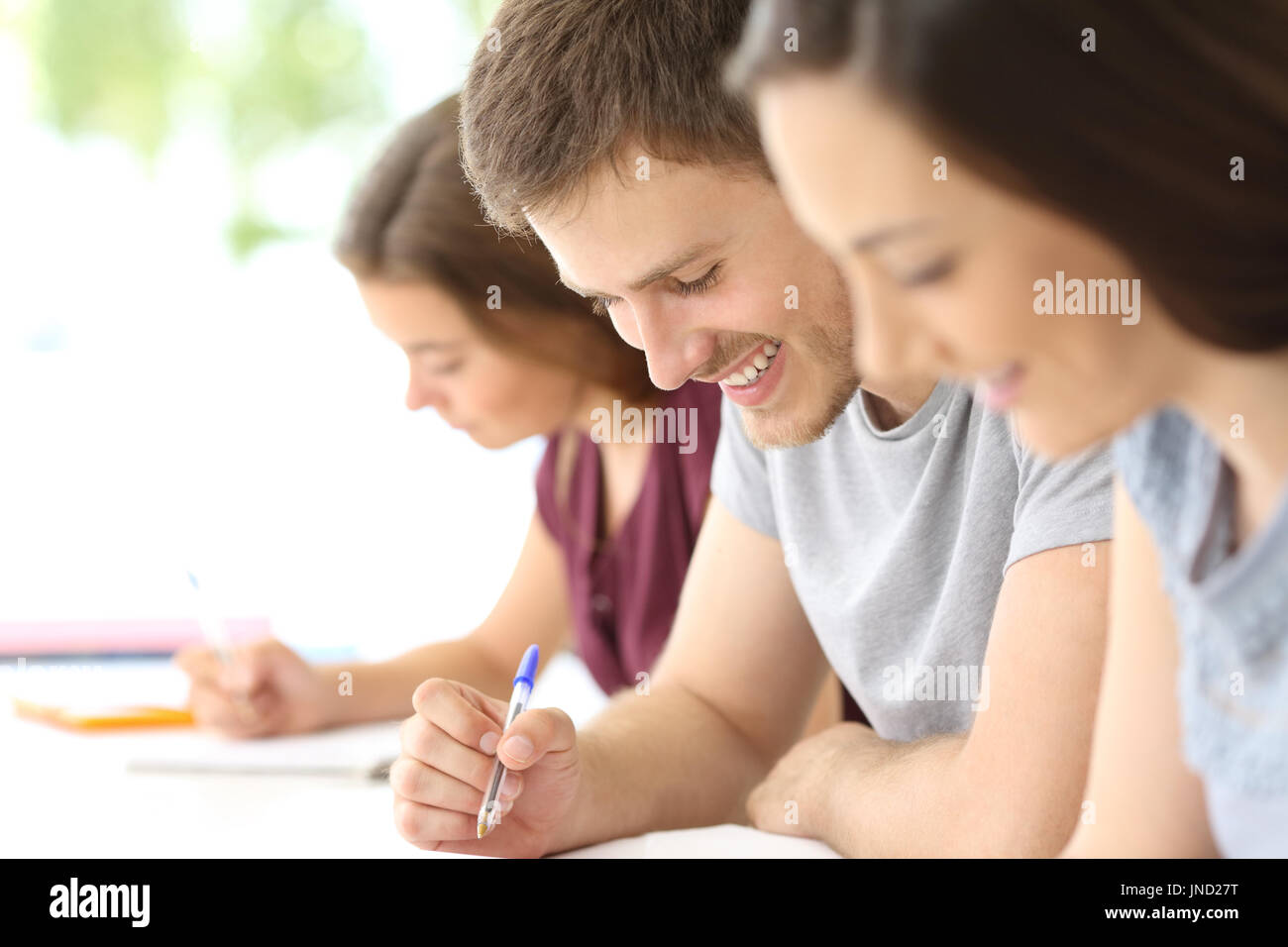 Nahaufnahme eines glücklichen Studenten Notizen in einem Klassenzimmer Stockfoto