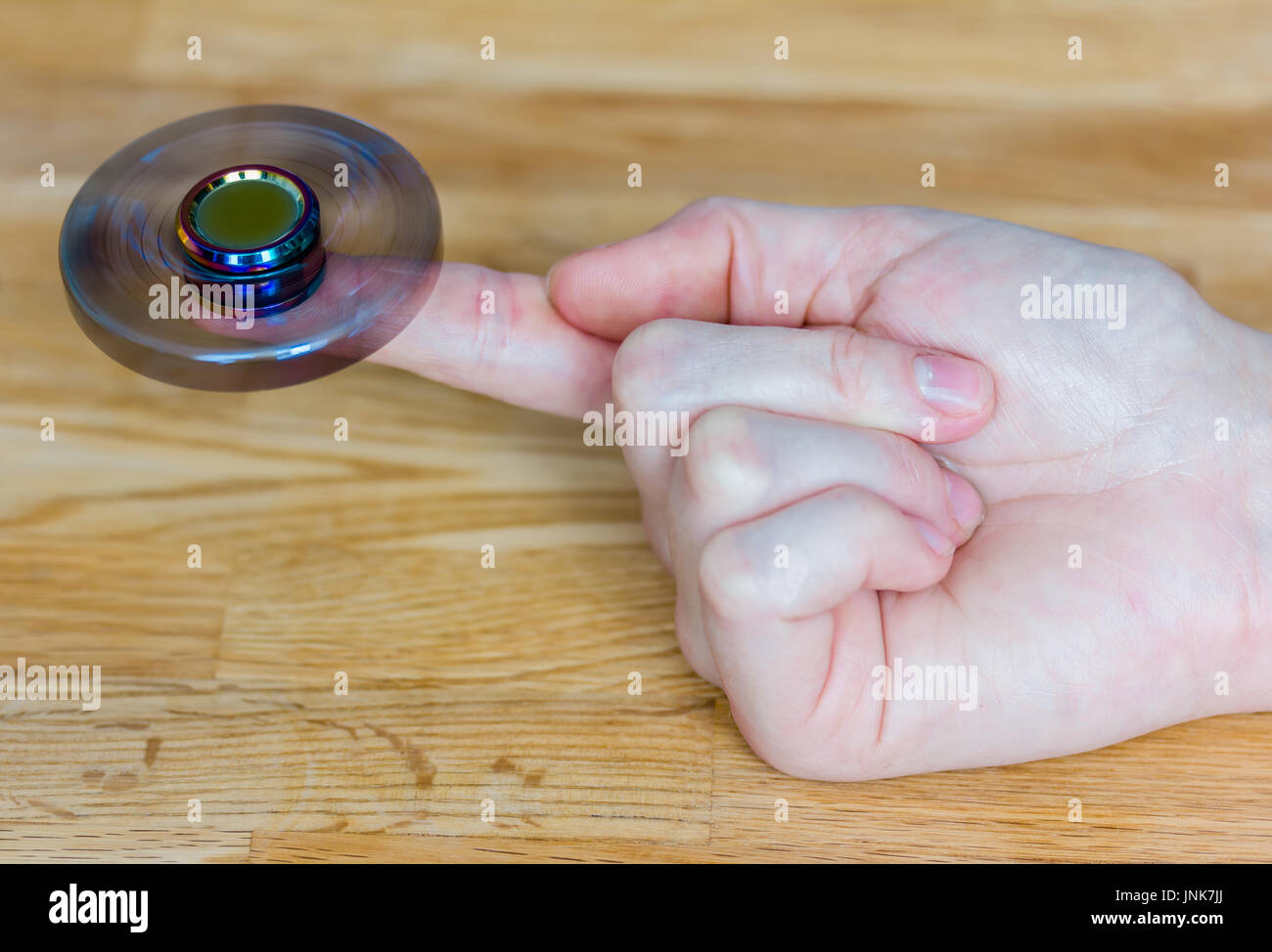 Eine exklusive Fidget Spinner aus Metall wird schnell auf der einen Seite Stockfoto