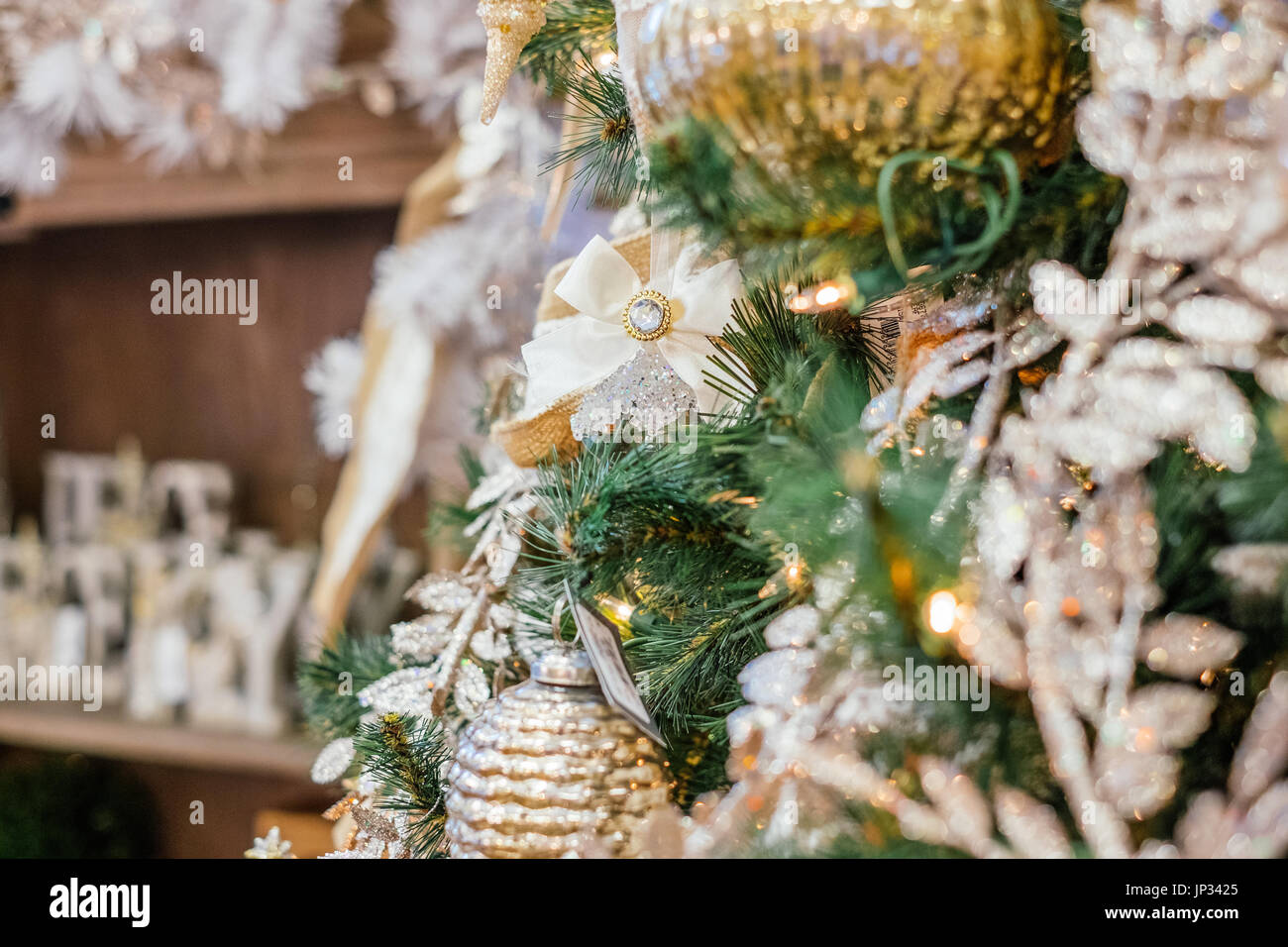 Christbaumschmuck und Lampen hängen an einem traditionellen Weihnachtsbaum während der Weihnachtszeit. Stockfoto