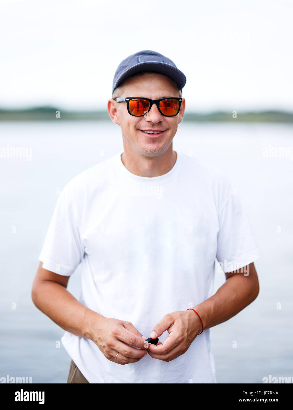 Outdoor Portrait ein hübscher junger Mann in Jeans und weißes T-shirt. Stockfoto