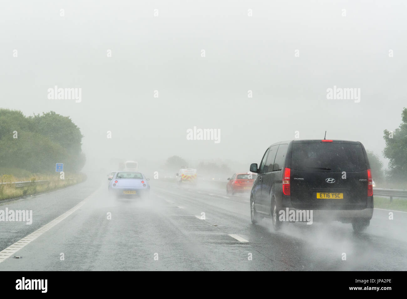 schlechten Sichtverhältnissen auf Großbritannien Autobahn durch Oberflächenwasser nach starkem Regen Stockfoto
