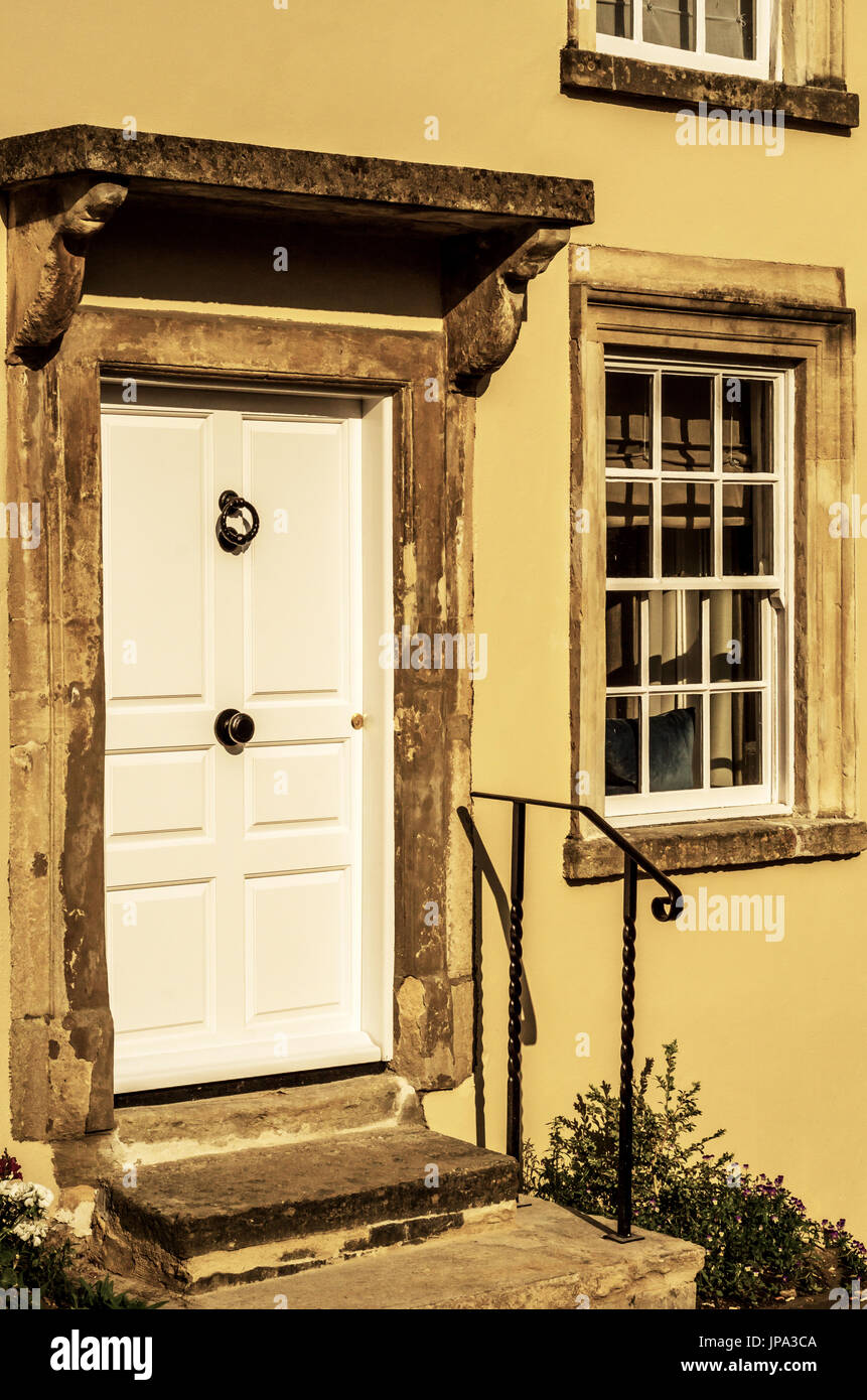 stilvolle Eintritt in ein Wohnhaus, eine interessante Fassade der alten Steinmauer, alte Holztür, typische alte englische Gebäude, Architektur Stockfoto
