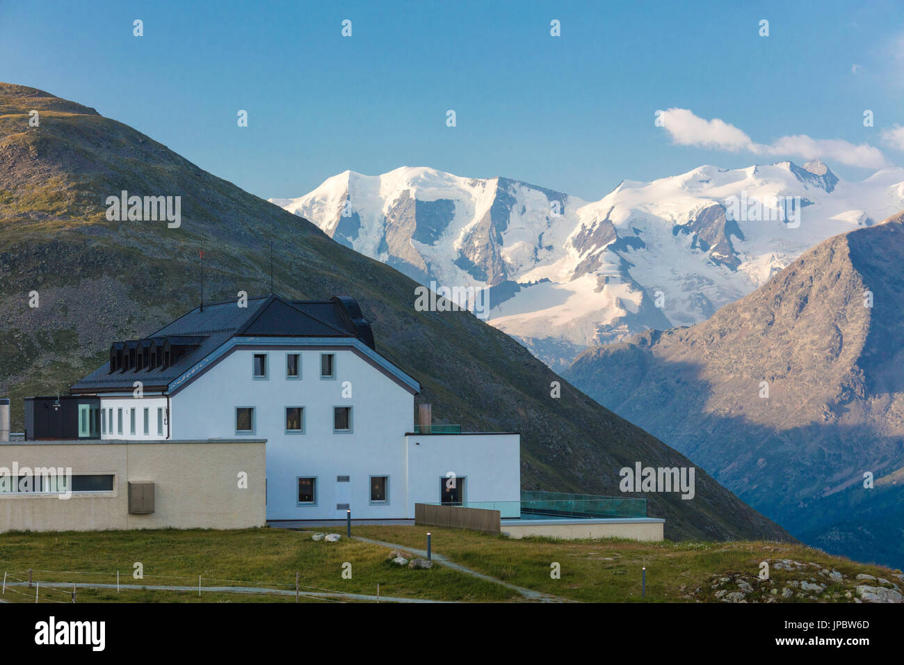 Das Hotel durch die hohen schneebedeckten Gipfeln Muottas Muragl Samedan Kanton Graubünden Engadin Schweiz Europa umgeben Stockfoto