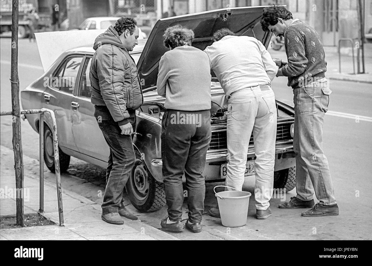 Vier Männer, die Reparatur eines Autos in Athen im Jahr 1986 Stockfoto