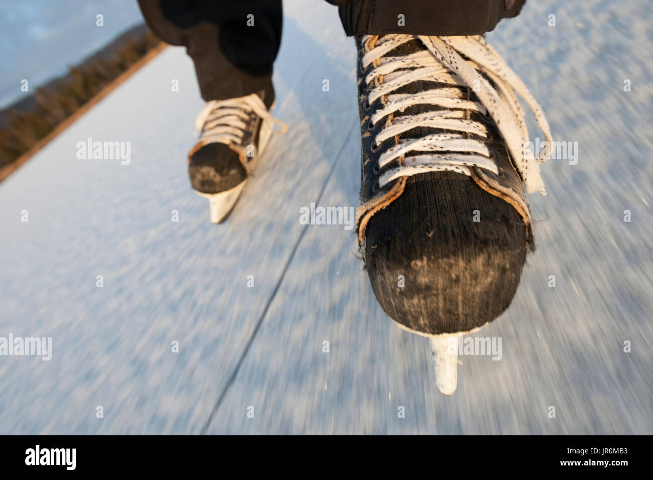 Eislaufen mit Hockey Skates auf einer gefrorenen Oberfläche, Alaska, Vereinigte Staaten von Amerika Stockfoto