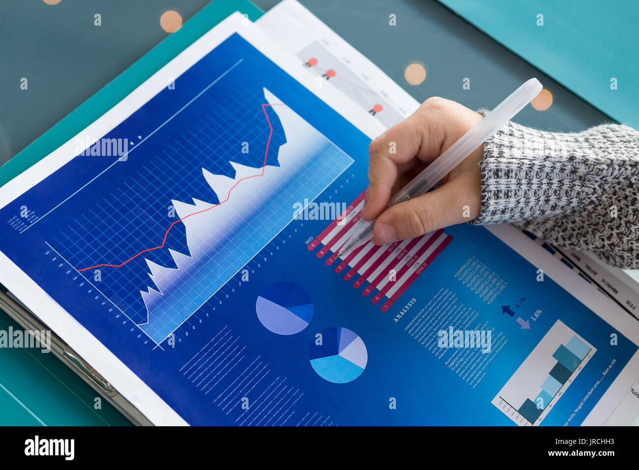 7/8 Hand des Kaufmanns Analyse der Daten in der Tabelle im Büro Stockfoto