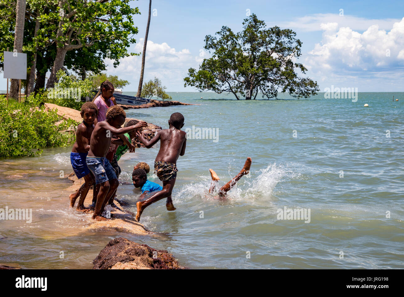 Torres Strait island Kinder spielen in König Gezeiten aus tief liegenden Saibai Insel Stockfoto
