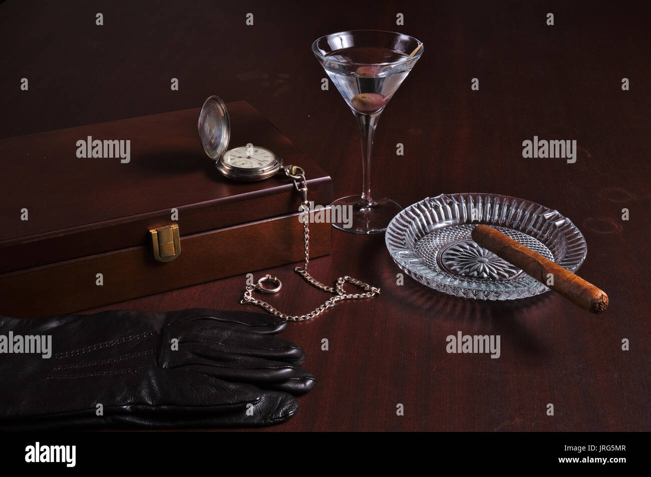 Cigarbox, Taschenuhr, Martini, kubanische Zigarre und Leder Handschuhe. vintage Herren Thema Stockfoto