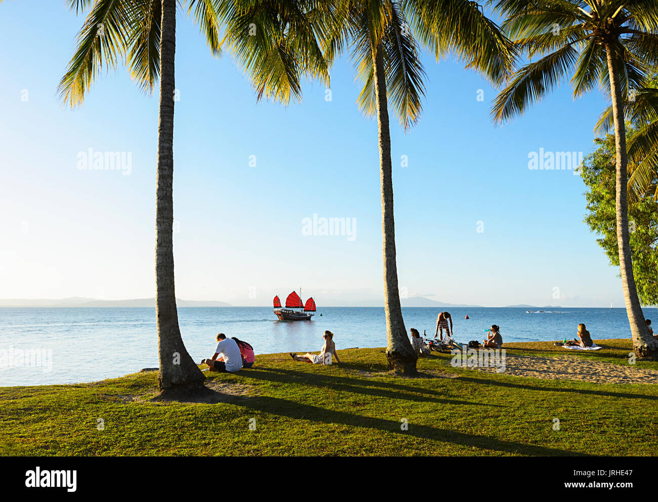 Eine Sunset Cruise chinesische Dschunke Segel Vergangenheit Menschen entspannen in Rex Smeal Park, Port Douglas, Far North Queensland, FNQ, QLD, Australien Stockfoto